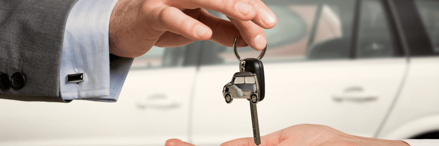 person handing keys to new car