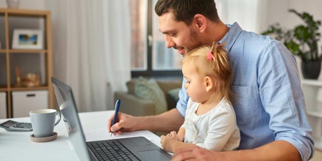Father with daughter working at home