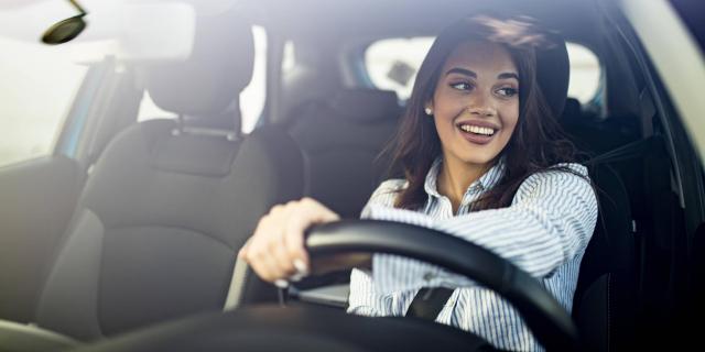 Woman smiling behind the steering wheel