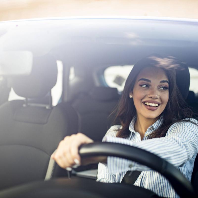 Woman smiling behind the steering wheel