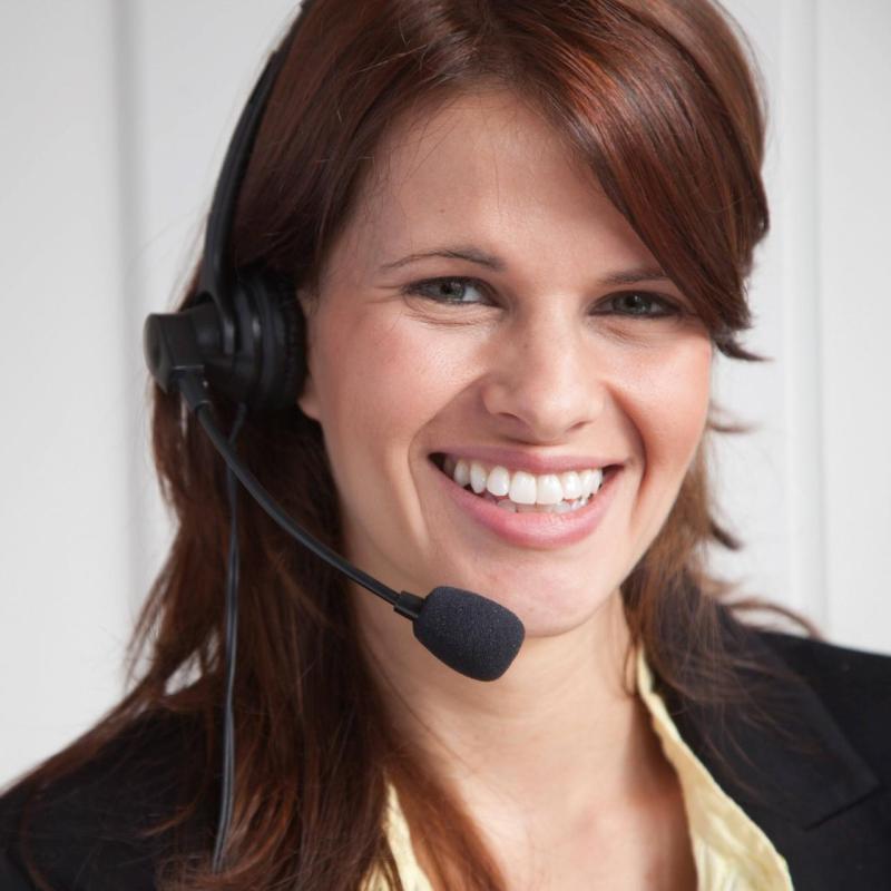 A woman smiling and wearing a headset