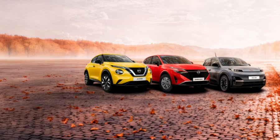 Juke, Micra and Qashqai parked on cobblestones with fallen leaves around them and an autumn forest in the background
