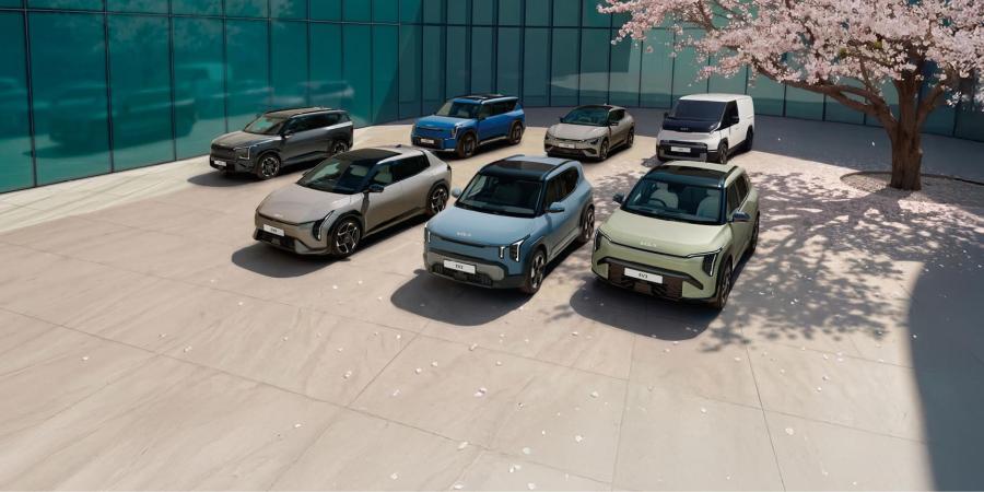 All cars of the Spring Deals parked on a square under a cherry blossom tree