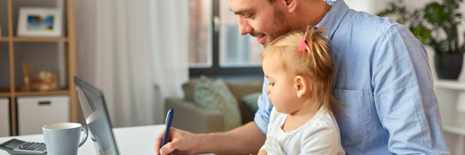 Father with daughter working at home