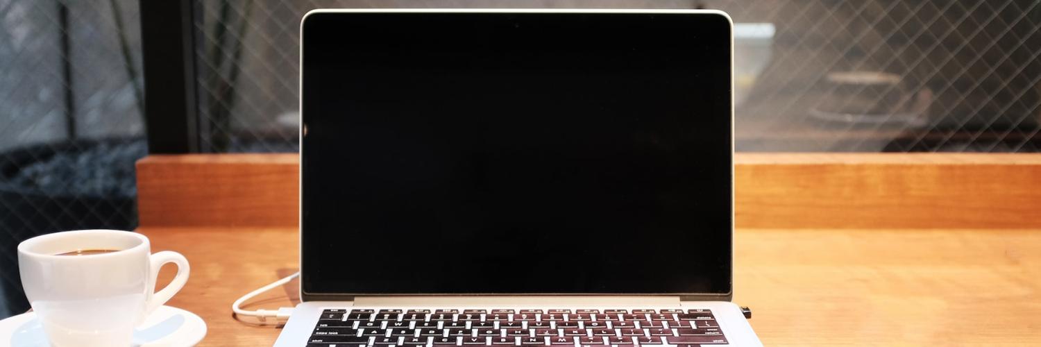 Laptop on desk with coffee