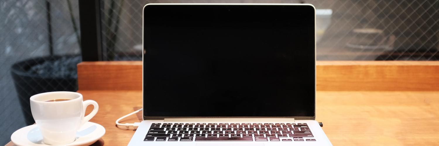 Laptop on desk with coffee Laptop on desk with coffee