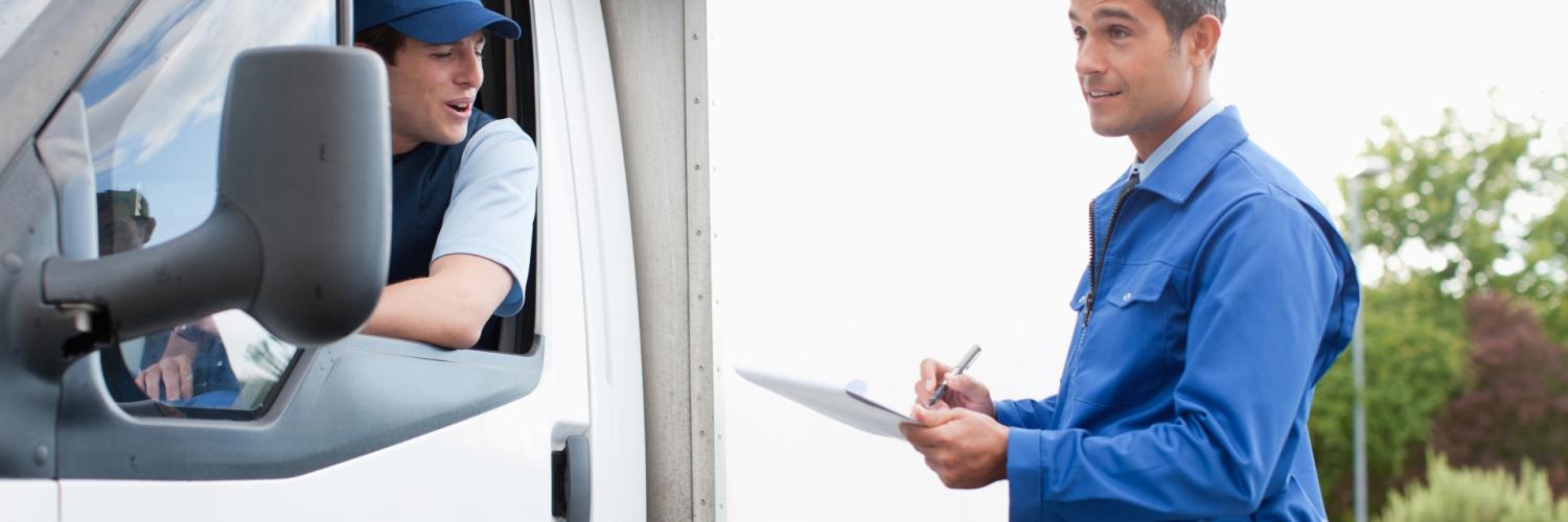 A man holding a clipboard next to a LCV