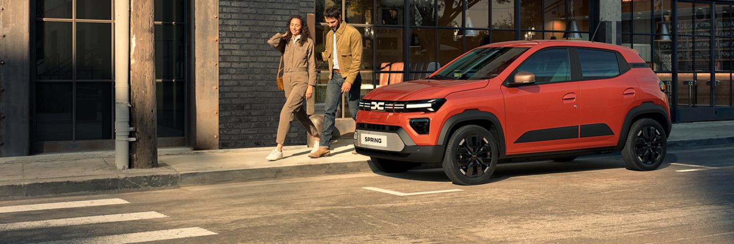 Dacia Spring parked on a busy city street