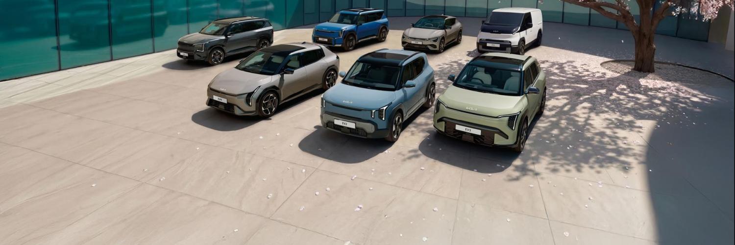 All cars of the Spring Deals parked on a square under a cherry blossom tree