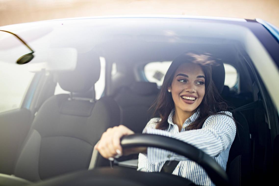 Woman smiling behind the steering wheel