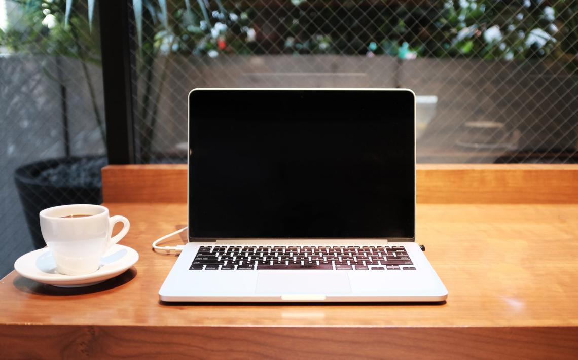 Laptop on desk with coffee