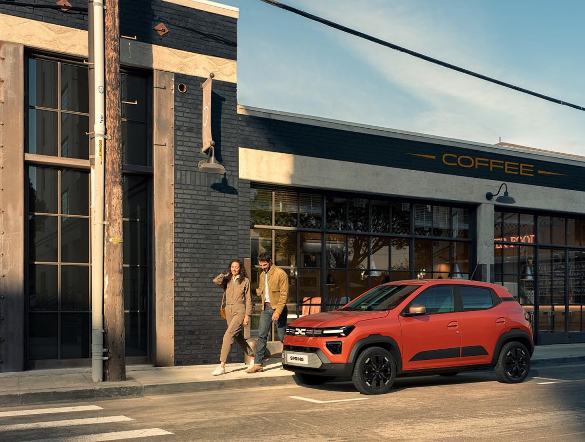 Dacia Spring parked on a busy city street